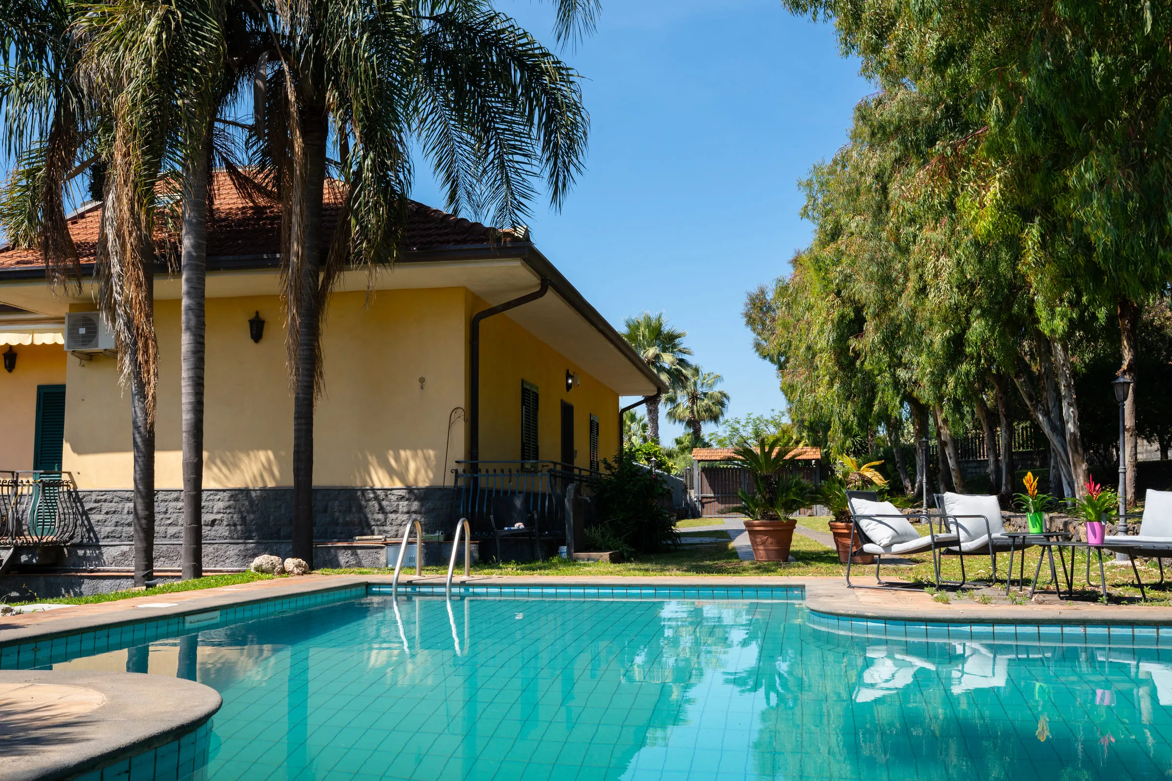 The Silvanae villa, its pool and garden above the Riviera dei Ciclopi.