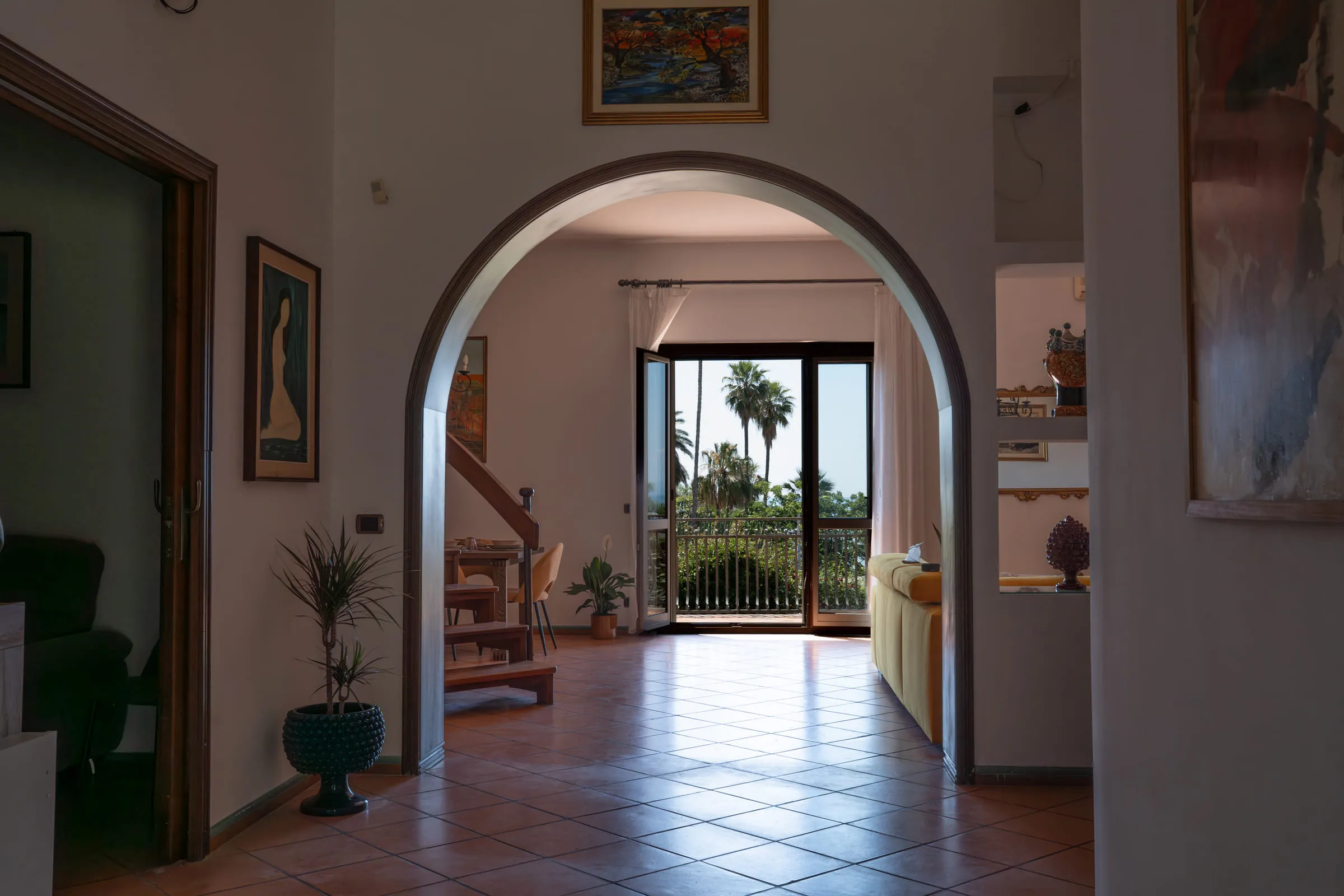 The arched entrance opening onto the living room and a French window to the garden.