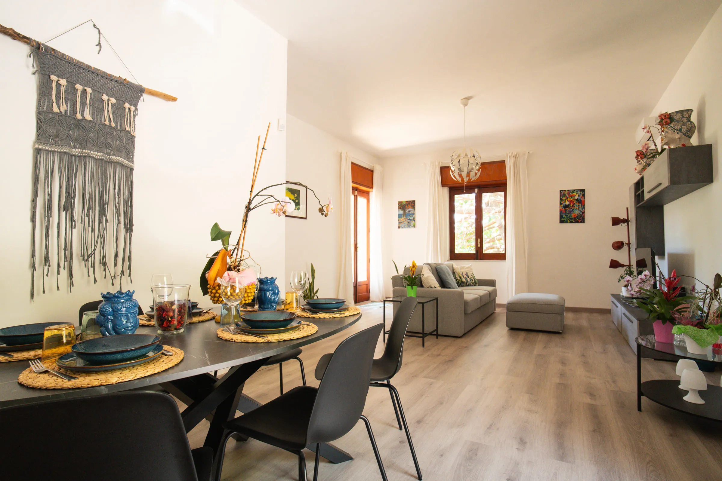 The dining table laid in the foreground, with the living room behind.