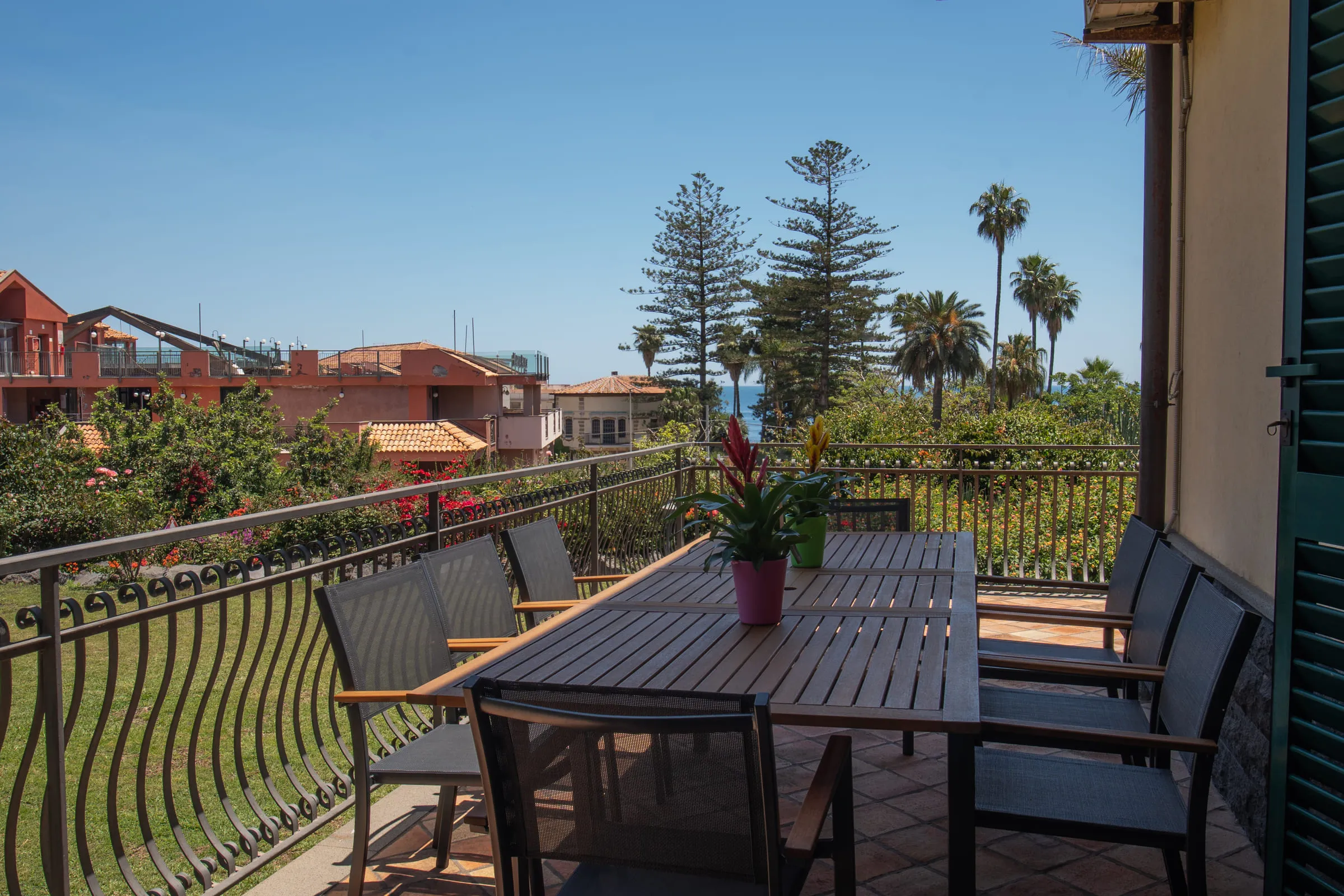 The balcony with its dining table, looking over the garden and the rooftops.