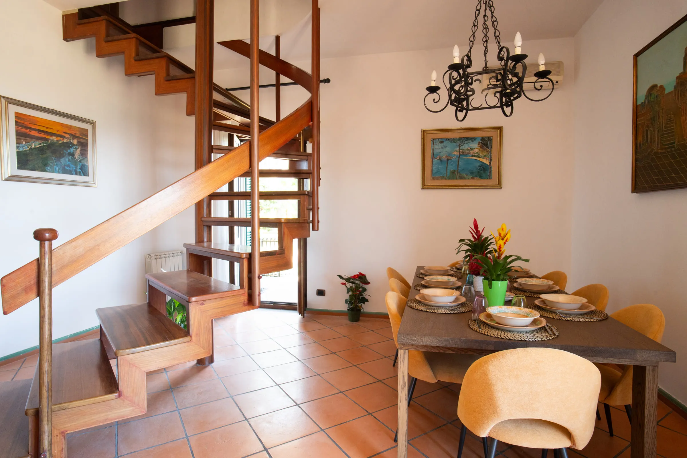 The dining area laid for a meal beside the spiral staircase.