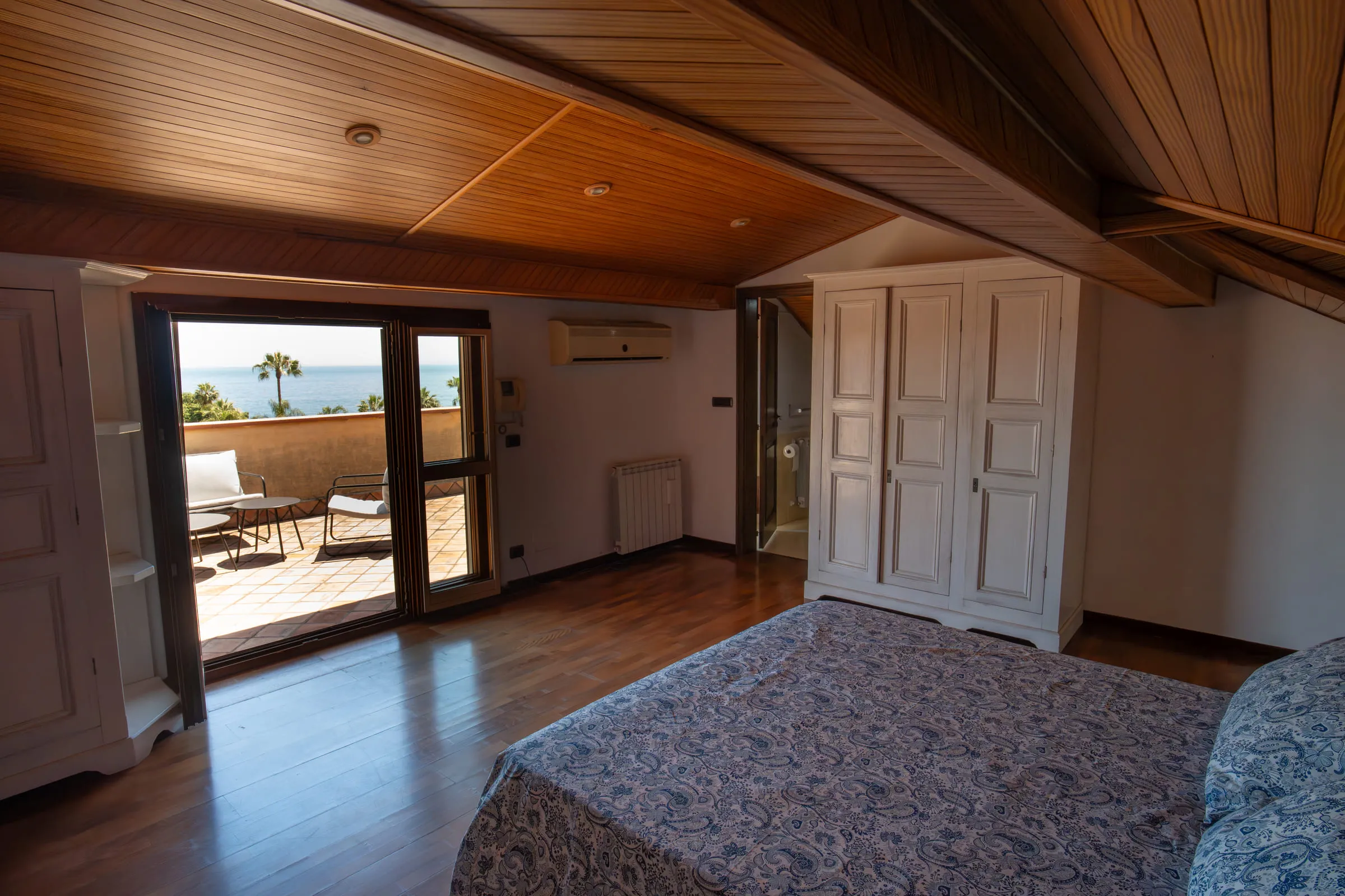 Attic double bedroom with a door onto the sea-view terrace.