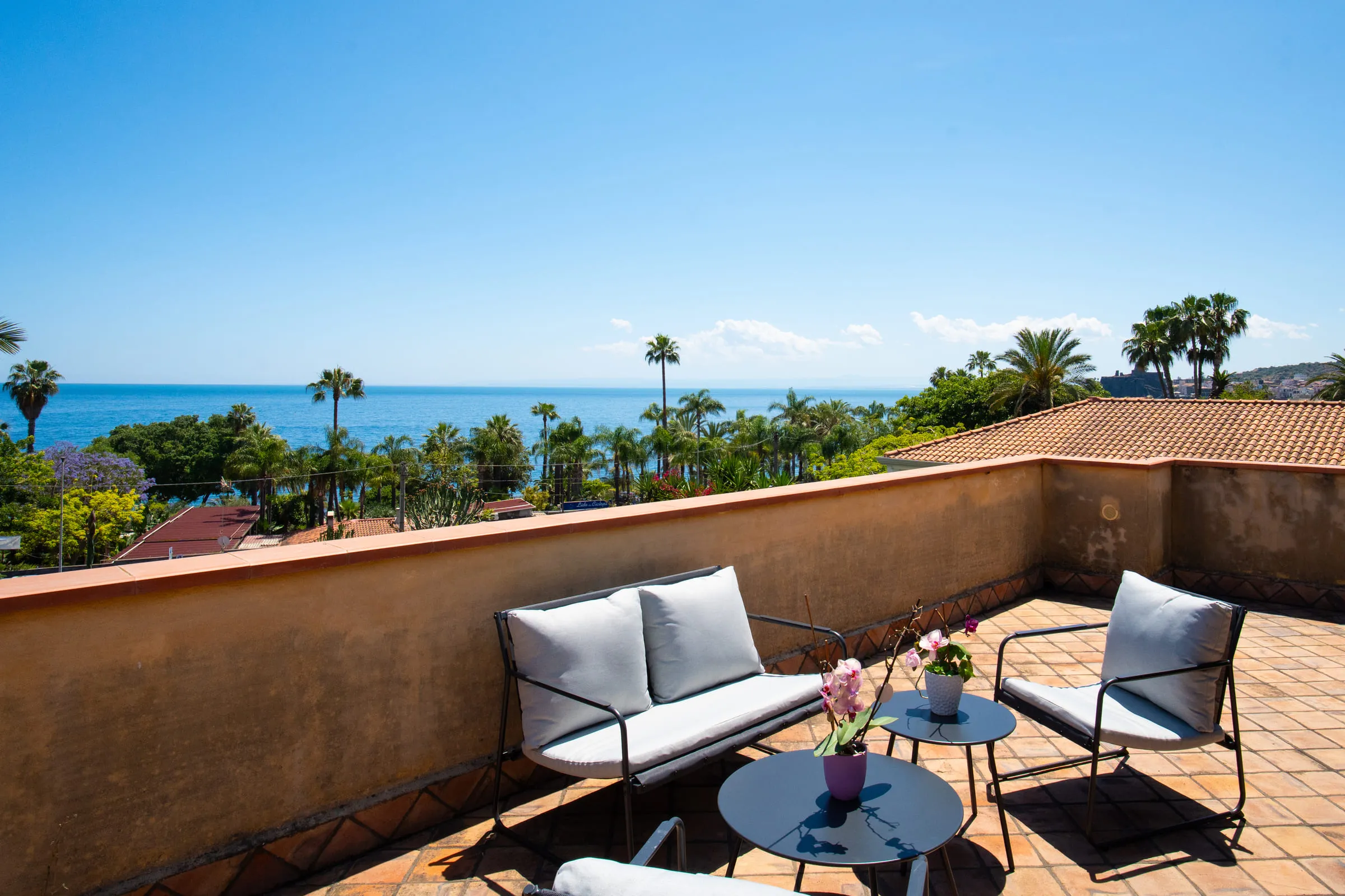 The villa's terrace facing the sea, with armchairs and low tables.
